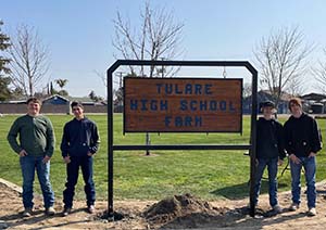 Students with Tulare High School Farm sign