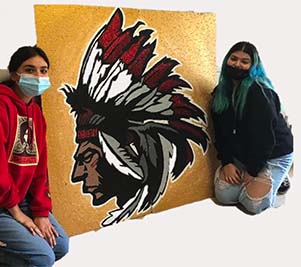 Students with art of man in headdress